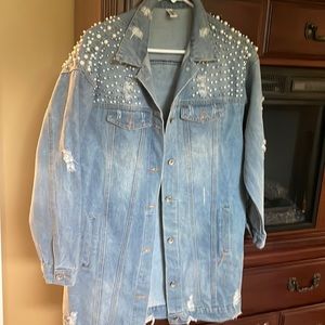 Distressed and embellished light wash denim jacket